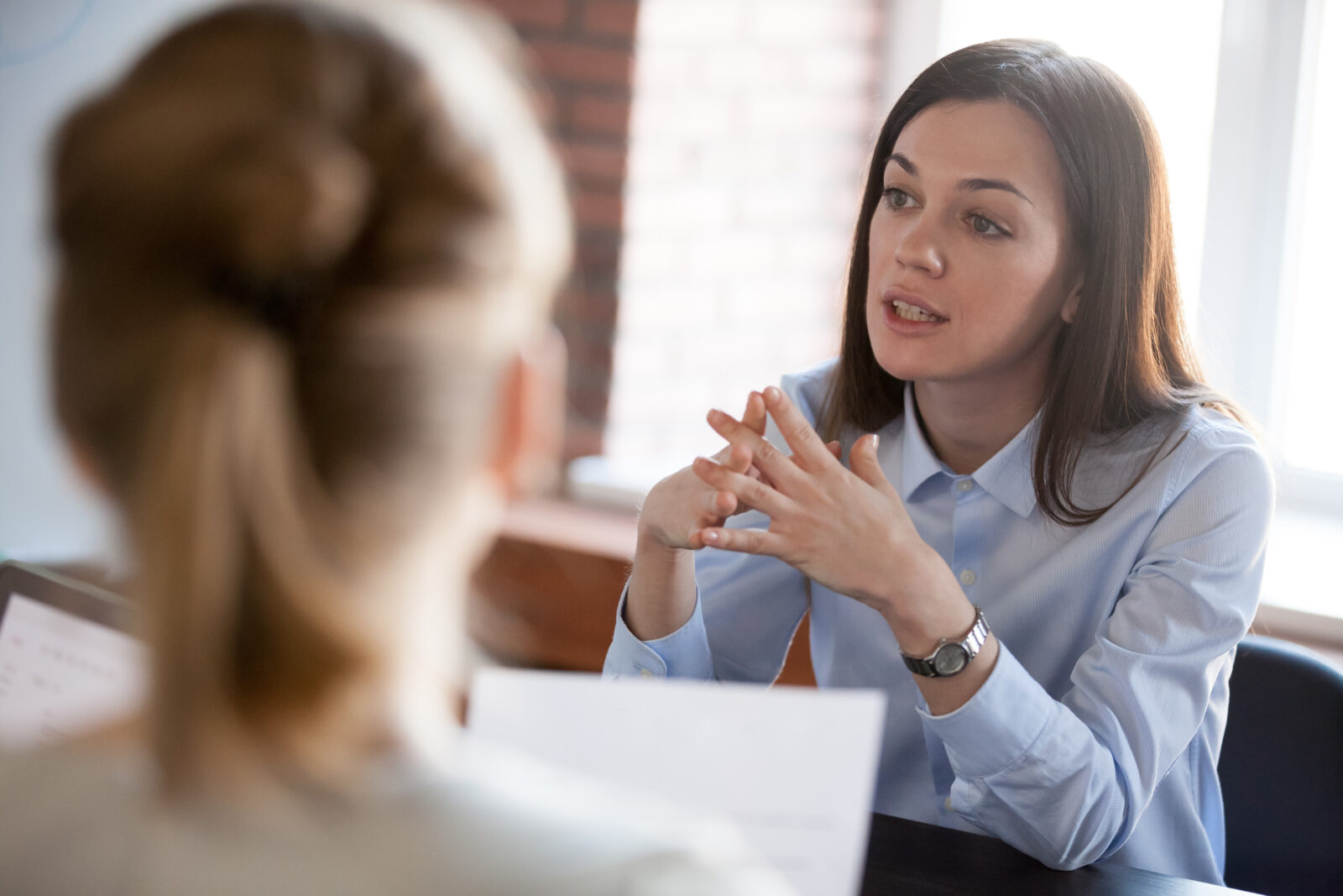 A named Spectra consultant talking through a client's compliance plan across a desk